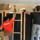 two guys removing damaged drywall