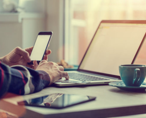 smartphone and laptop with coffee cup