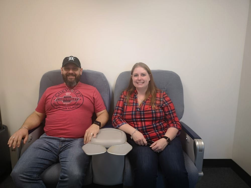 couple sitting on airplane chairs