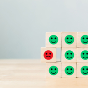 group of smiley faces with one frowning face