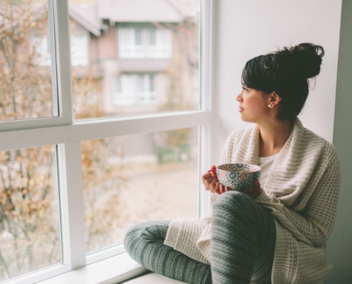 woman looking out of window