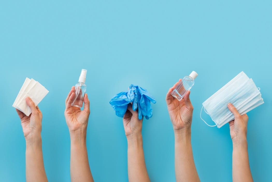hands holding personal protective equipment