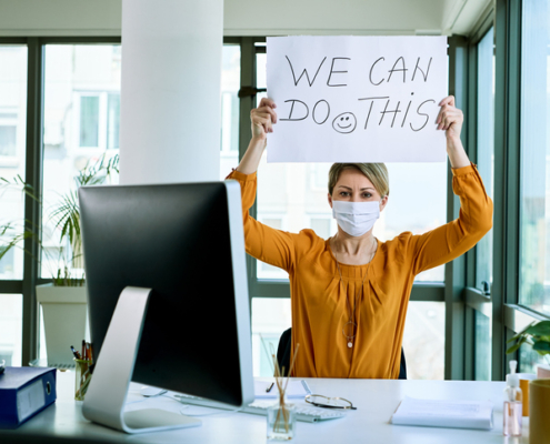 Businesswoman holding placard with we can do this text as support during virus epidemic.
