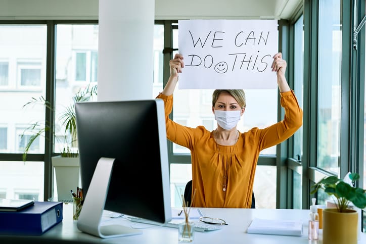 Businesswoman holding placard with we can do this text as support during virus epidemic.