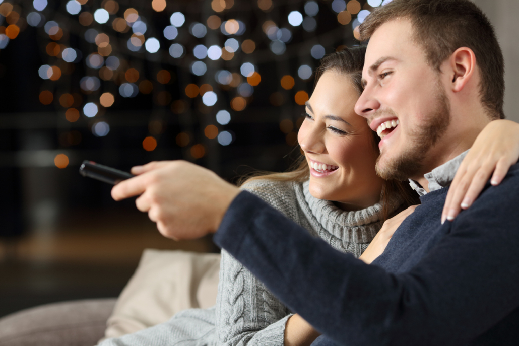 couple laughing while watching tv