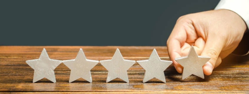 hand setting down 5th star on wood table