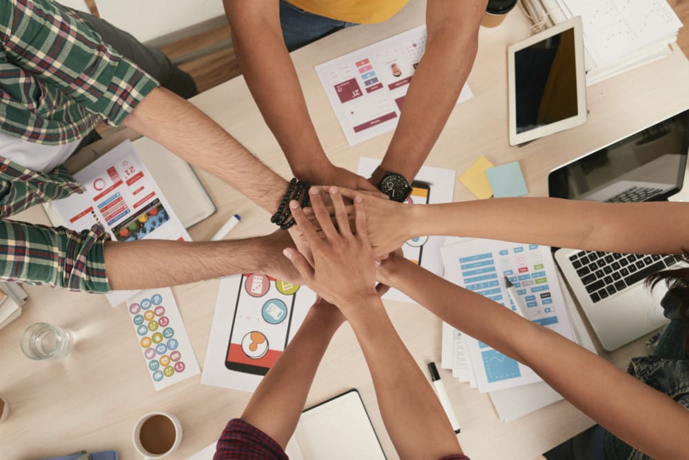 team with hands together