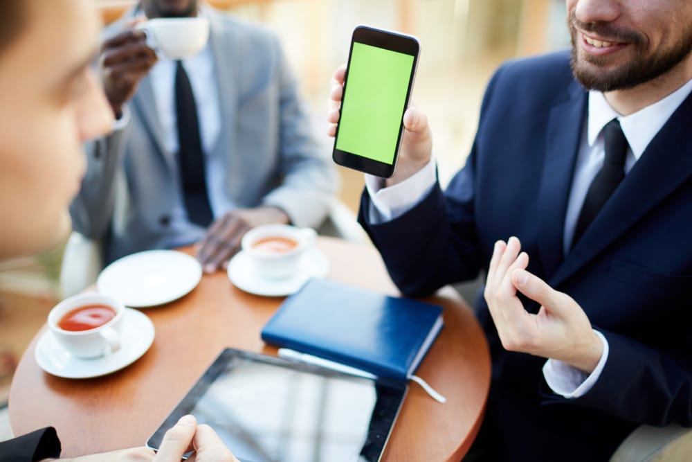 businessman showing his phone