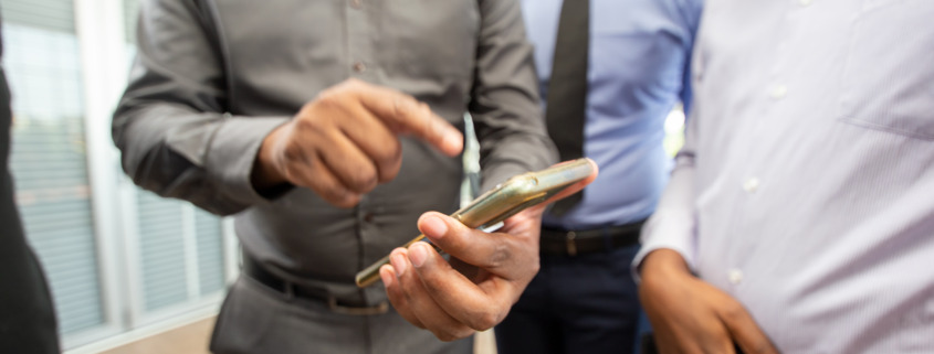 group looking at smartphone