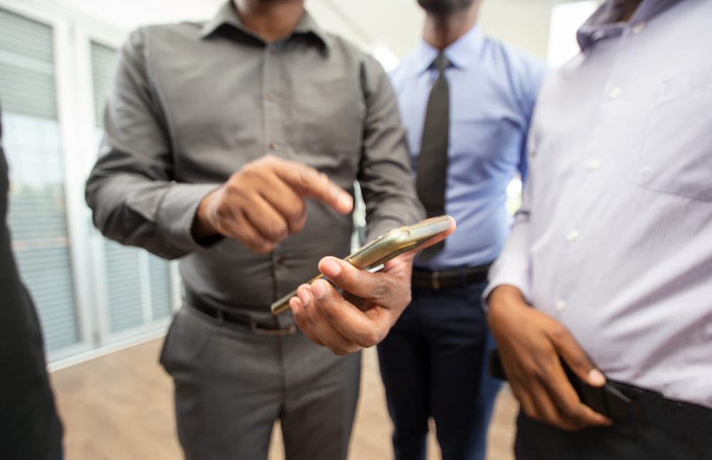 group looking at smartphone
