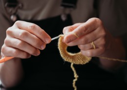 woman's hands crocheting