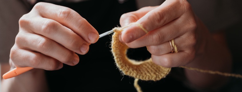 woman's hands crocheting
