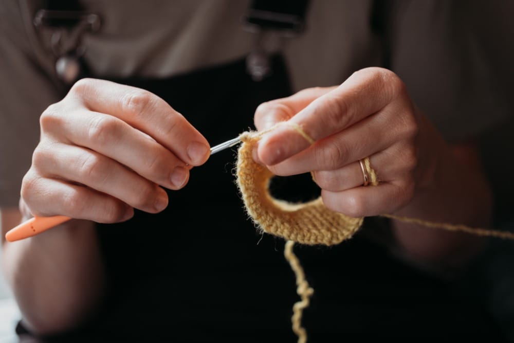 woman's hands crocheting
