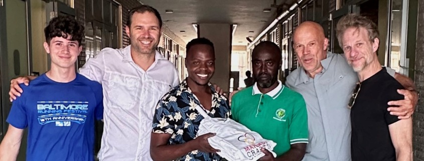 smiling group of people holding shirts