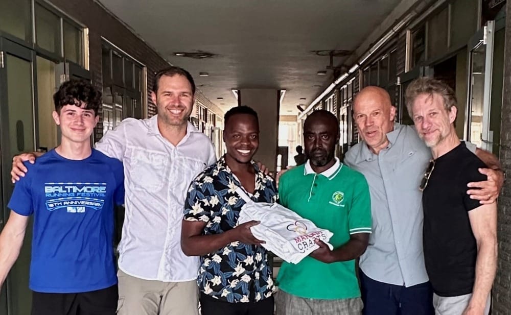 smiling group of people holding shirts