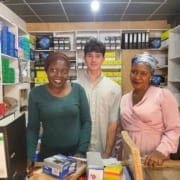 man with two women at a small print shop