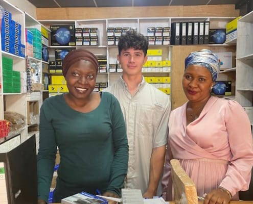 man with two women at a small print shop