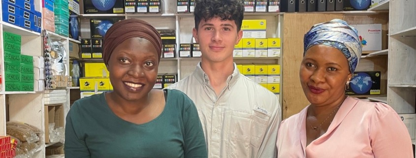 man with two women at a small print shop