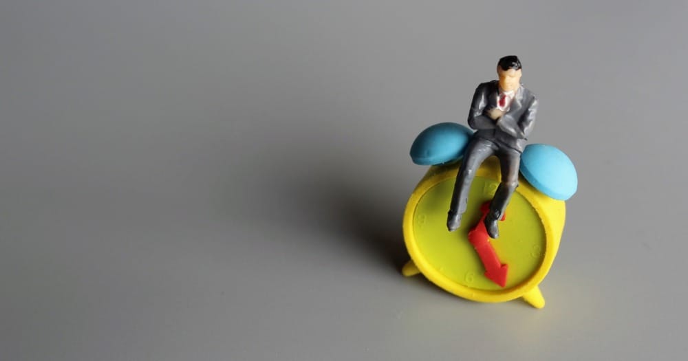 man sitting on clock