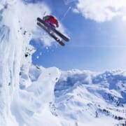 Skier jumping snowy slope