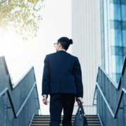 Young businessman walking up stairs in an urban setting