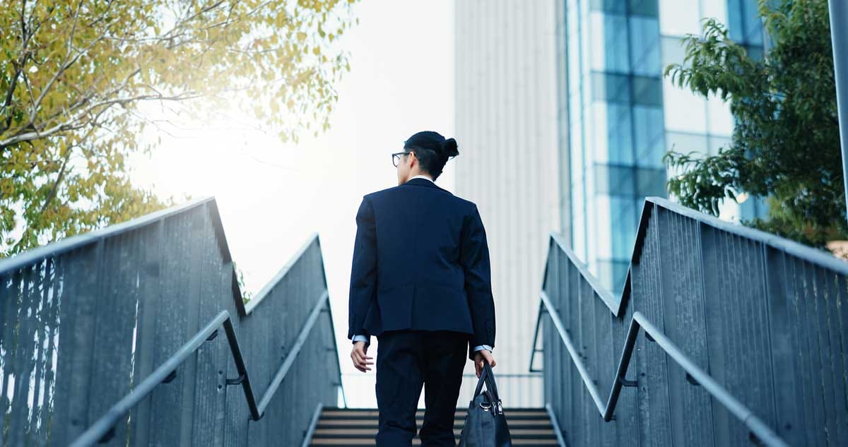 Young businessman walking up stairs in an urban setting