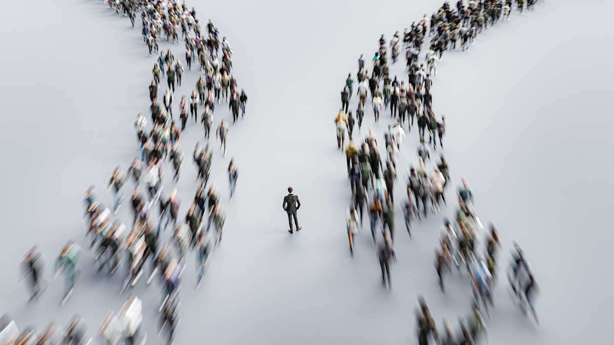 Two lines of people flowing past a business person in the middle.