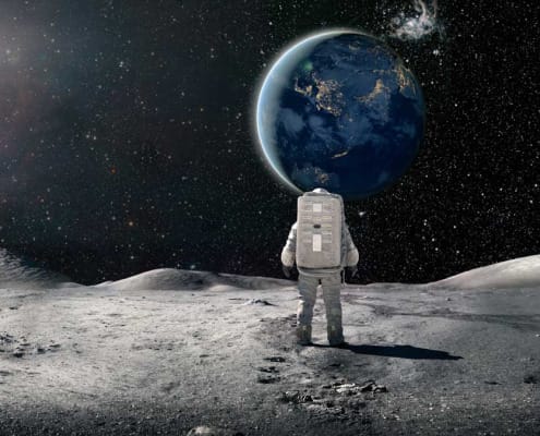 Astronaut standing on the moon and looking at earth