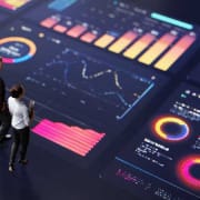 Executives-standing-on-dashboard Two executives talking and standing on a giant executive data dashboard