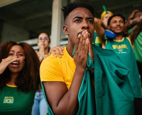 Sports fans at game watching critical moment with focus