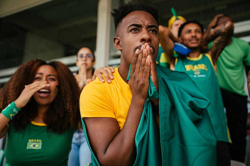 Sports fans at game watching critical moment with focus