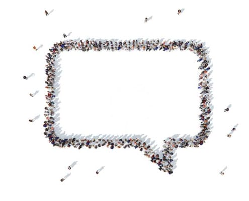 Overhead view of a chat bubble icon formed by people