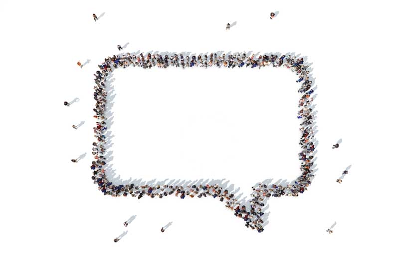 Overhead view of a chat bubble icon formed by people