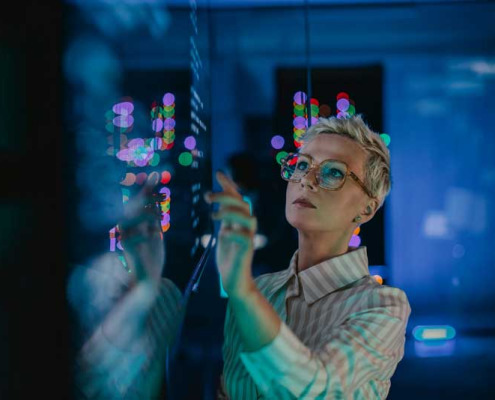 woman interacting with data displayed on a giant screen